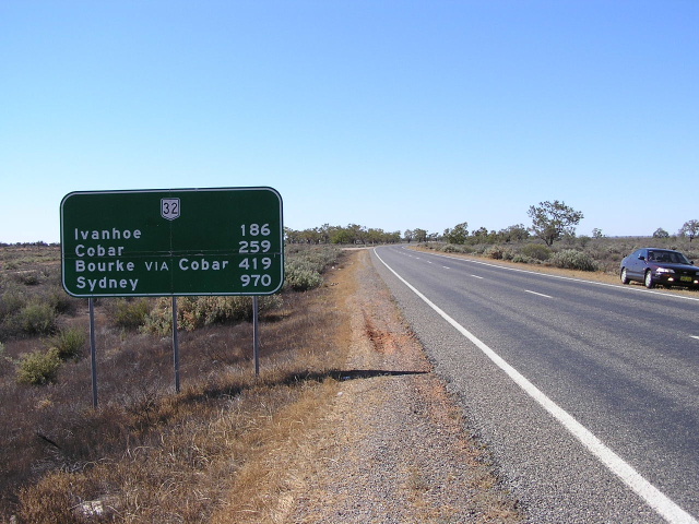 Distance sign heading south from Wilcannia across the Darling River flood 